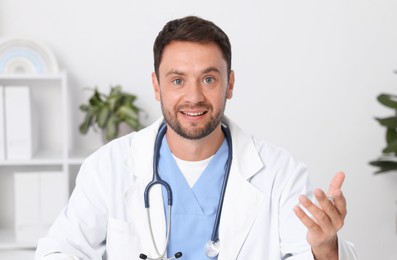 Photo of Pediatrician having video call with patient, view from camera