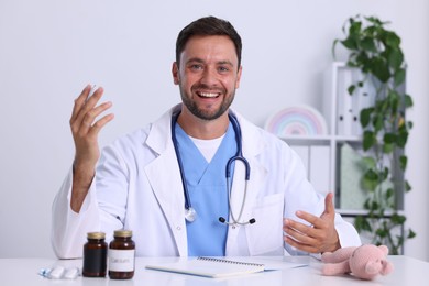 Photo of Pediatrician having video call with patient, view from camera