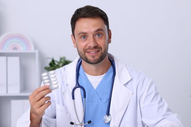 Photo of Pediatrician recommending pills during video call with patient, view from camera