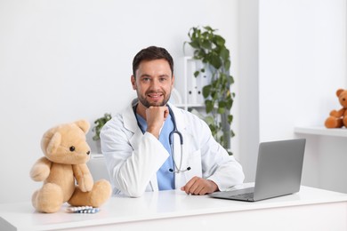 Photo of Pediatrician with laptop at desk in hospital