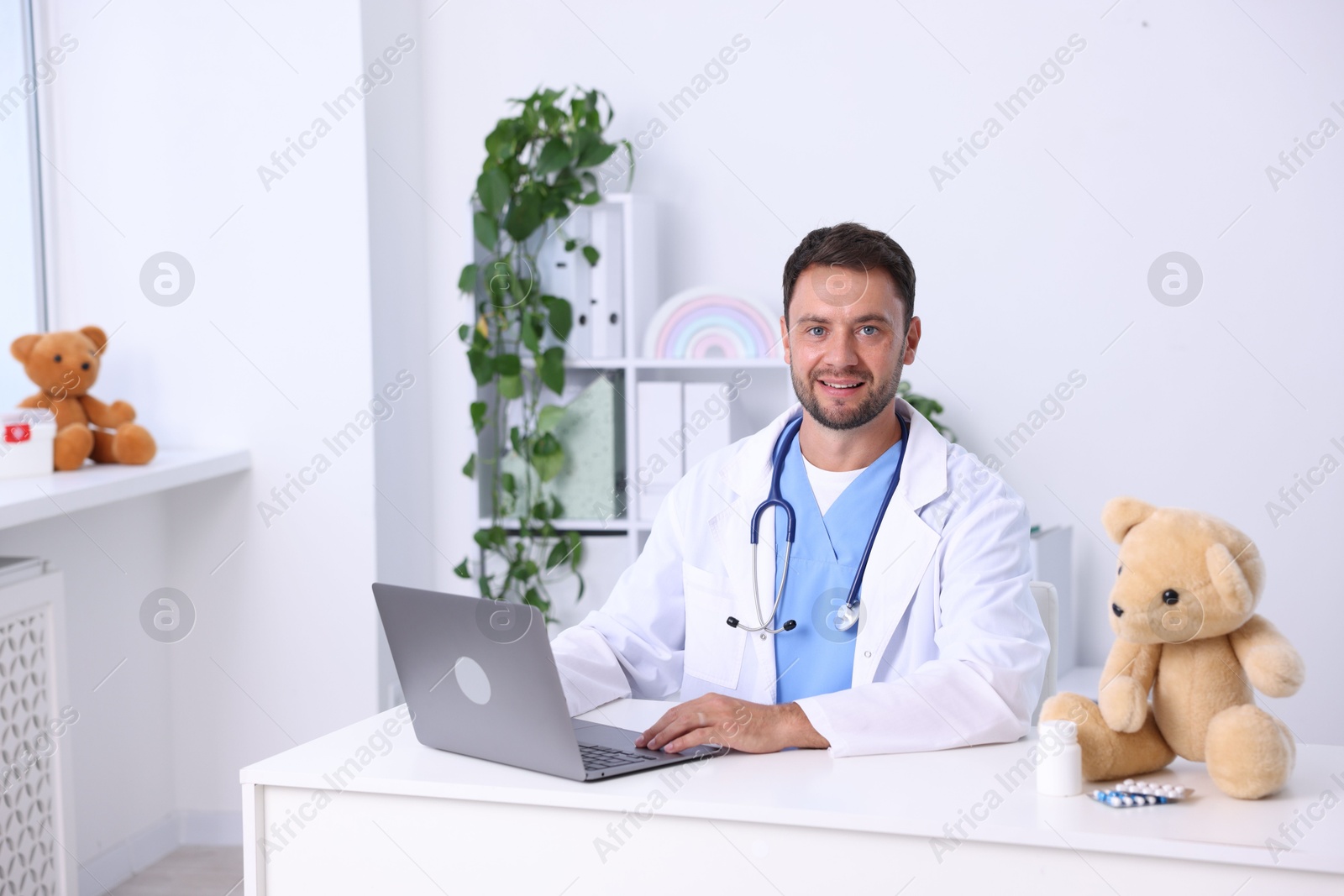 Photo of Pediatrician with laptop at desk in hospital
