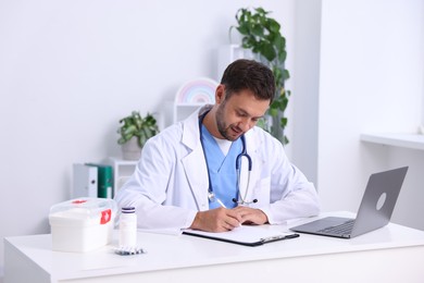 Photo of Professional pediatrician working at desk in hospital