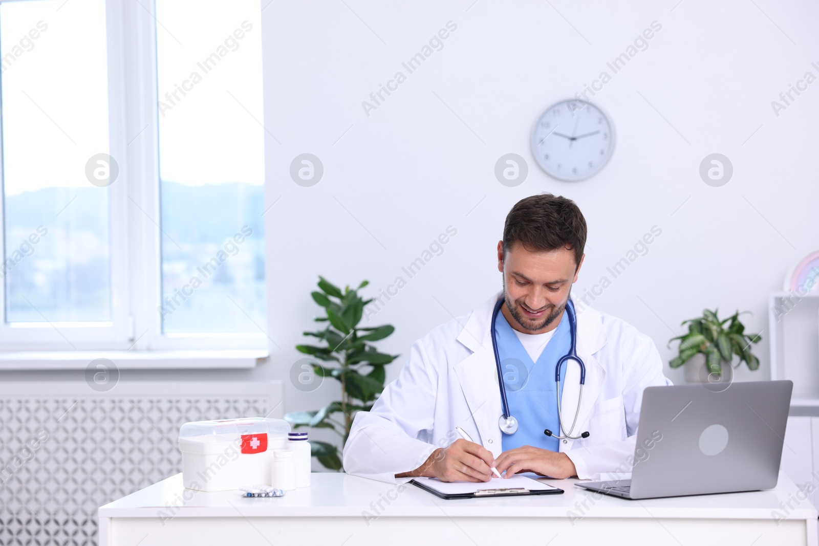 Photo of Professional pediatrician working at desk in hospital