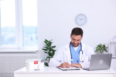 Photo of Professional pediatrician working at desk in hospital