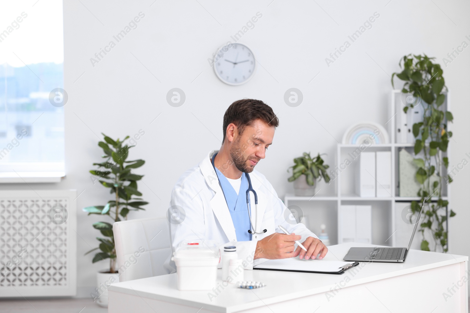 Photo of Professional pediatrician working at desk in hospital