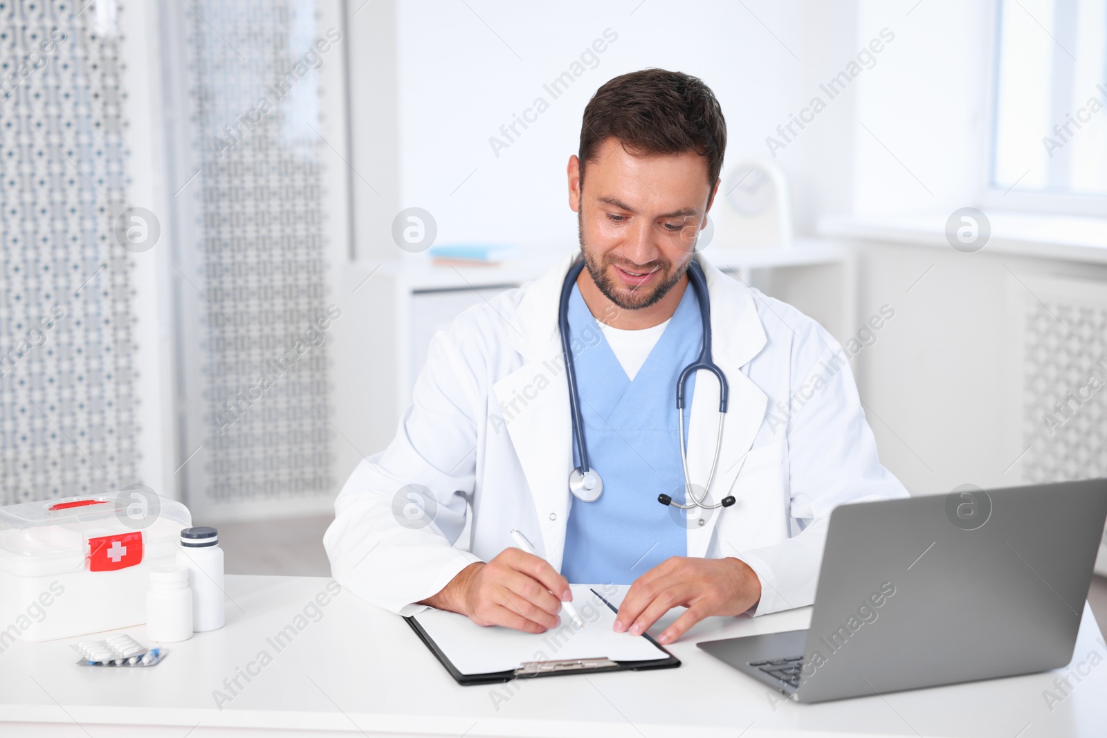 Photo of Professional pediatrician working at desk in hospital