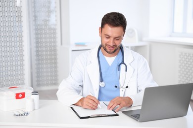 Photo of Professional pediatrician working at desk in hospital