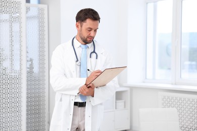 Photo of Pediatrician with stethoscope and clipboard in hospital