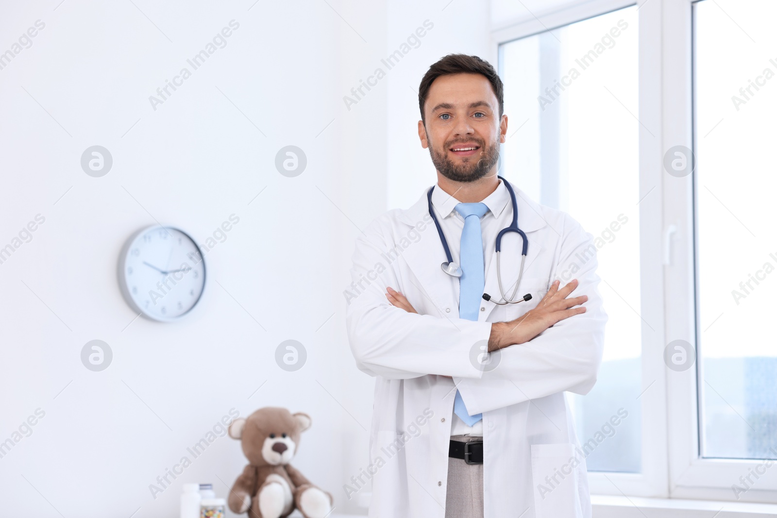 Photo of Pediatrician with stethoscope in hospital. Space for text