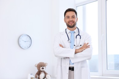 Photo of Pediatrician with stethoscope in hospital. Space for text