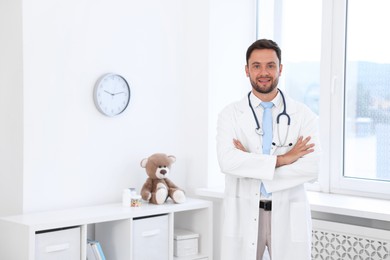 Photo of Pediatrician with stethoscope in hospital. Space for text