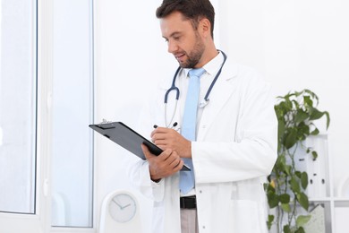 Photo of Pediatrician with stethoscope and clipboard in hospital