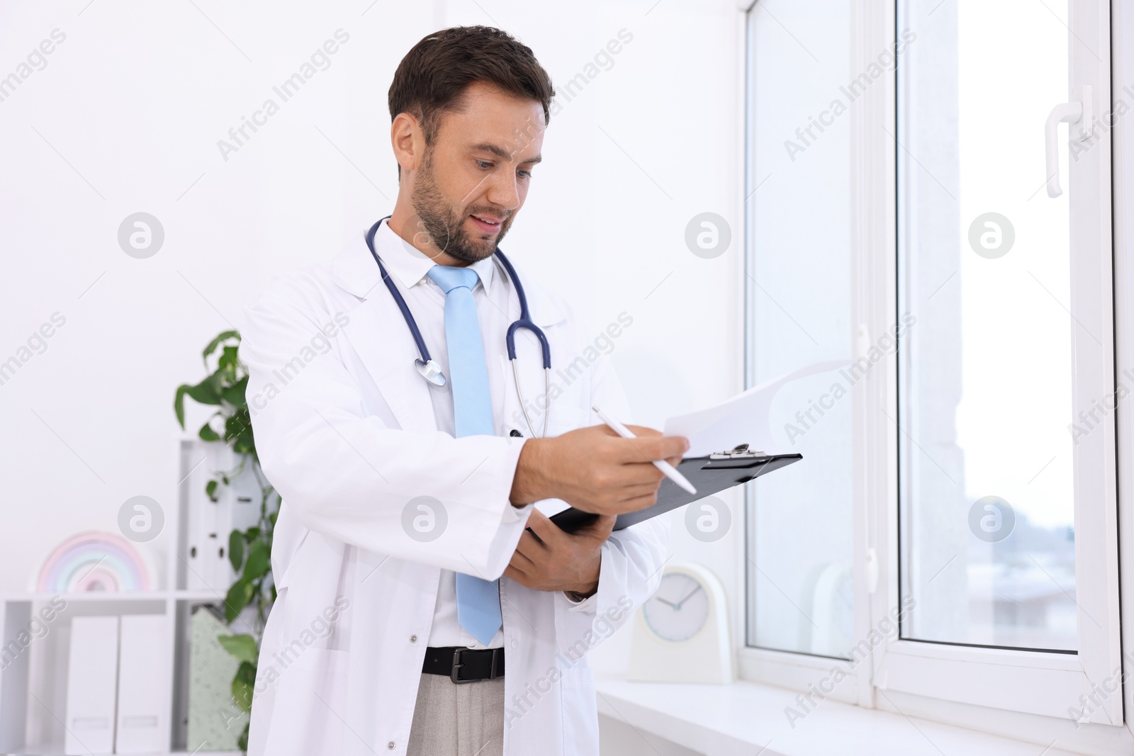 Photo of Pediatrician with stethoscope and clipboard in hospital