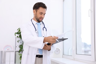 Photo of Pediatrician with stethoscope and clipboard in hospital