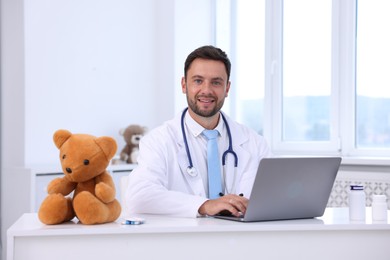 Photo of Pediatrician with laptop at desk in hospital