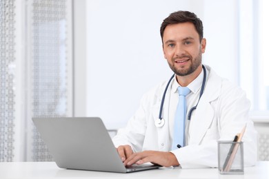 Photo of Pediatrician with laptop at desk in hospital