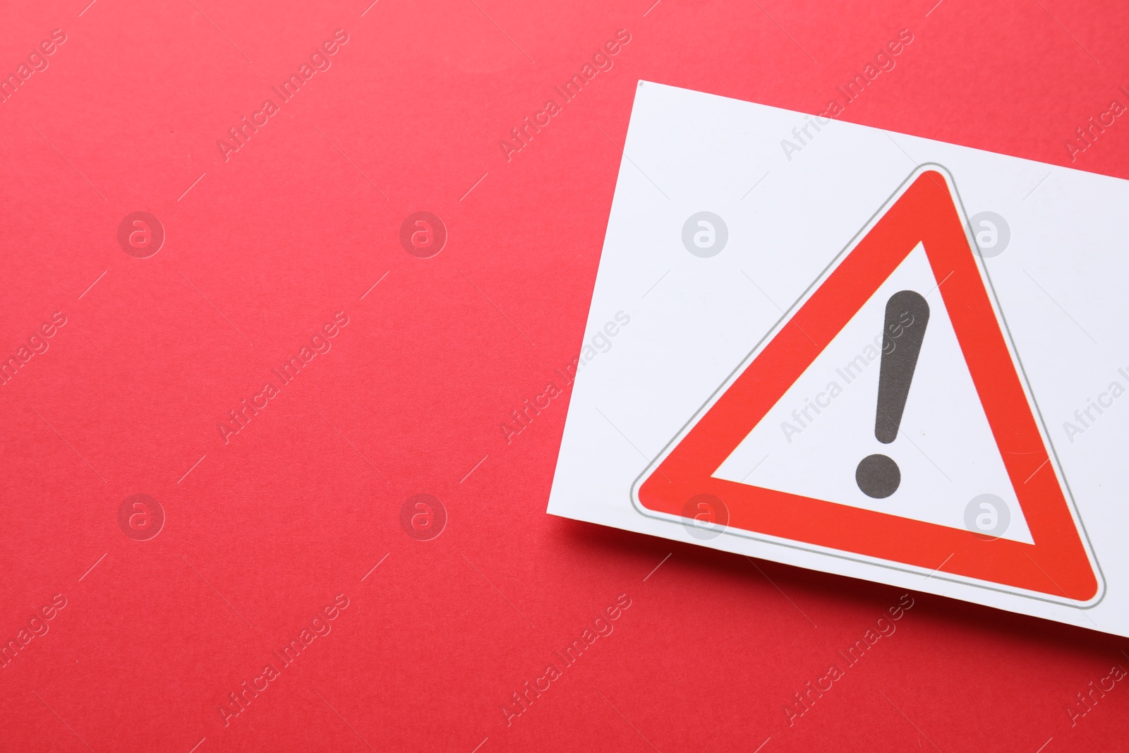 Photo of Risk. Sheet of paper with warning sign on red background, top view and space for text