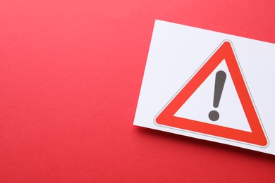 Photo of Risk. Sheet of paper with warning sign on red background, top view and space for text