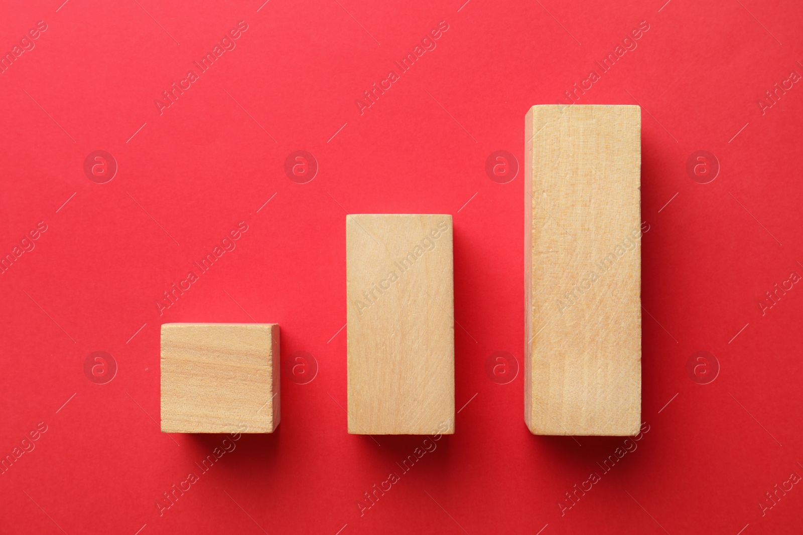 Photo of Blank wooden blocks on red background, flat lay