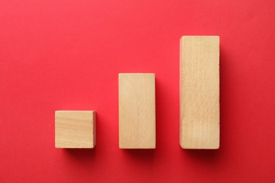 Photo of Blank wooden blocks on red background, flat lay