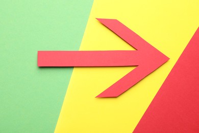 Photo of Risk. Red arrow on color background, flat lay