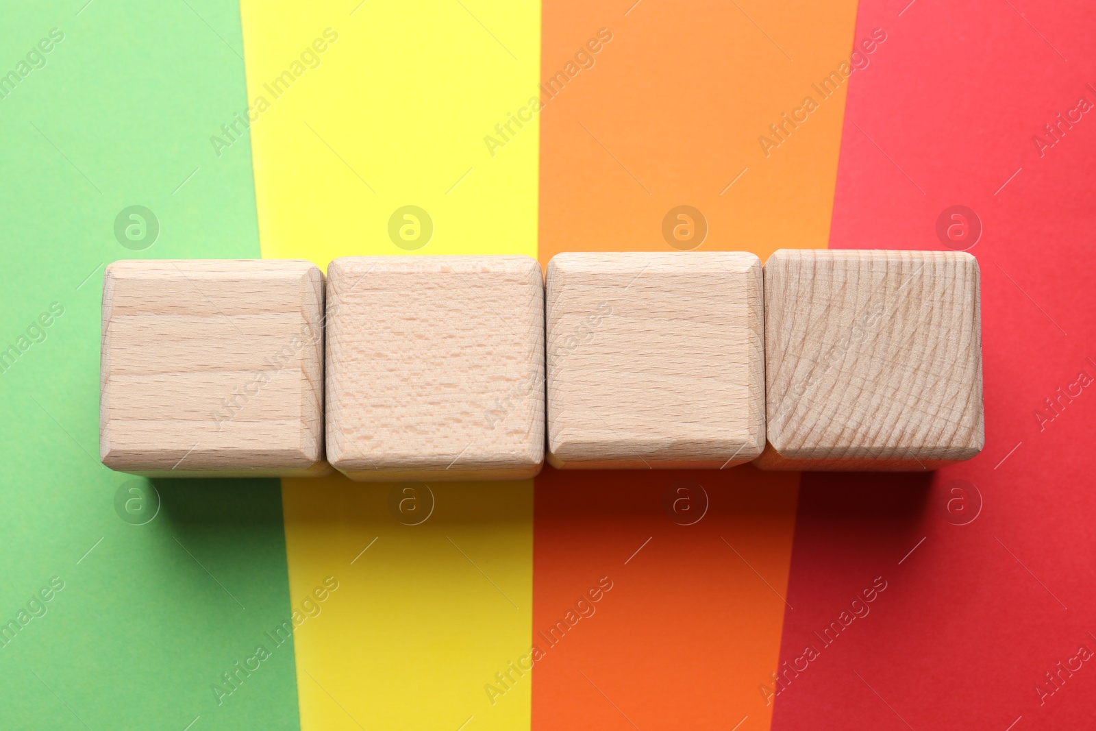 Photo of Blank wooden cubes on color background, flat lay