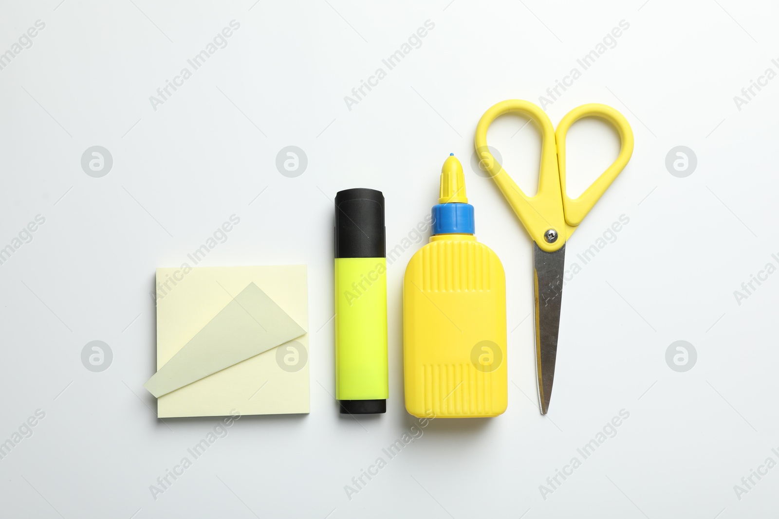 Photo of Glue and other stationery on white background, flat lay