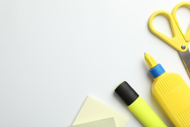 Photo of Glue and other stationery on white background, flat lay. Space for text