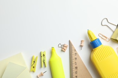 Photo of Glue and other stationery on white background, flat lay. Space for text