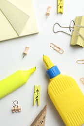 Photo of Glue and other stationery on white background, flat lay