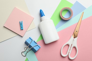 Photo of Glue and other stationery on white background, flat lay