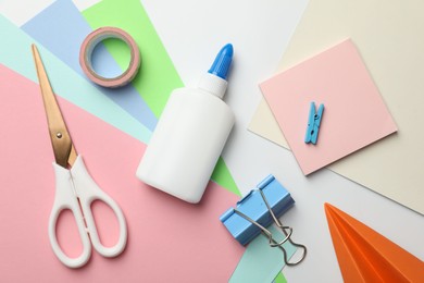 Photo of Glue and other stationery on white background, flat lay