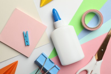 Photo of Glue and other stationery on white background, flat lay