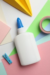 Photo of Glue and other stationery on white background, flat lay