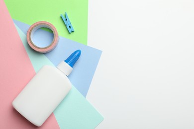 Photo of Glue and other stationery on white background, flat lay. Space for text