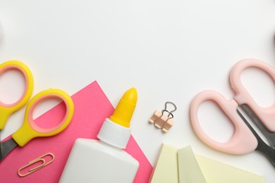 Photo of Glue and other stationery on white background, flat lay. Space for text