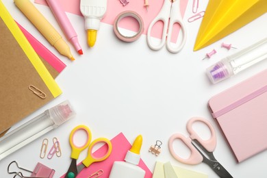 Photo of Frame of glue and other stationery on white background, flat lay. Space for text