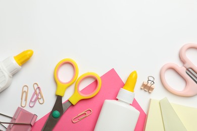 Photo of Glue and other stationery on white background, flat lay. Space for text