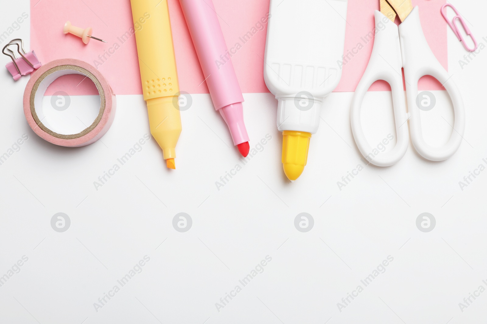 Photo of Glue and other stationery on white background, flat lay. Space for text