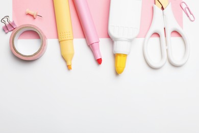 Photo of Glue and other stationery on white background, flat lay. Space for text