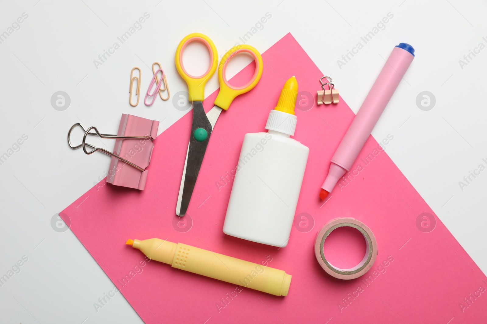 Photo of Glue and other stationery on white background, flat lay