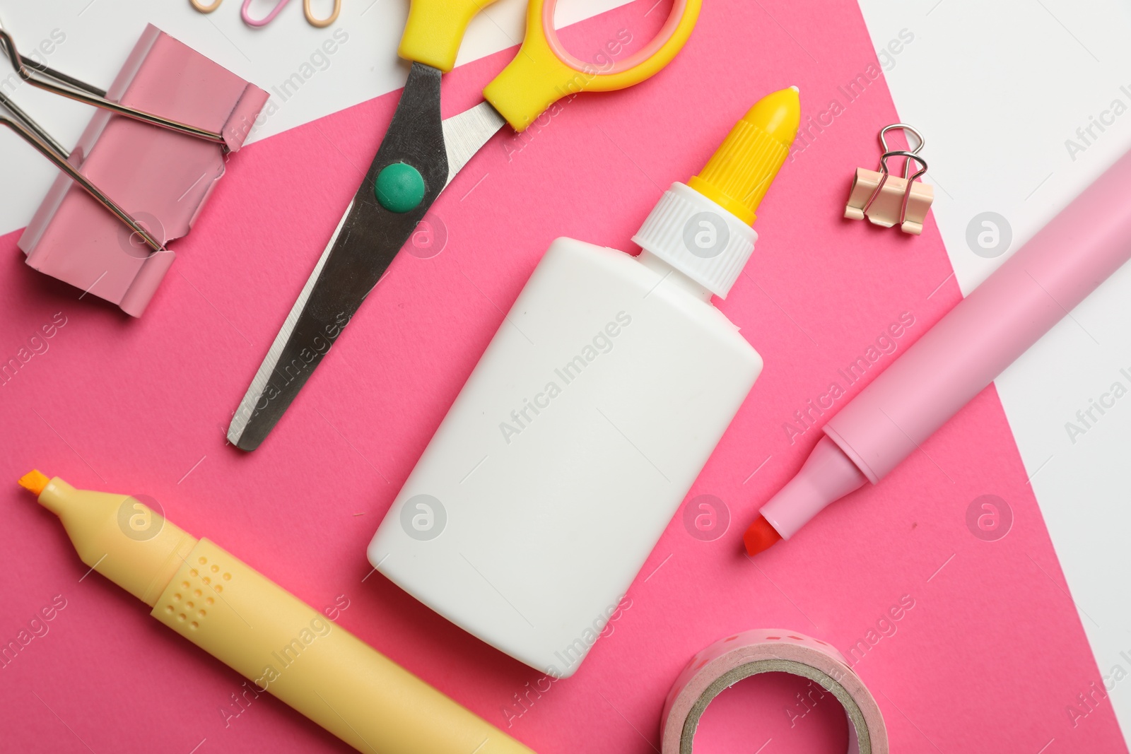 Photo of Glue and other stationery on white background, flat lay