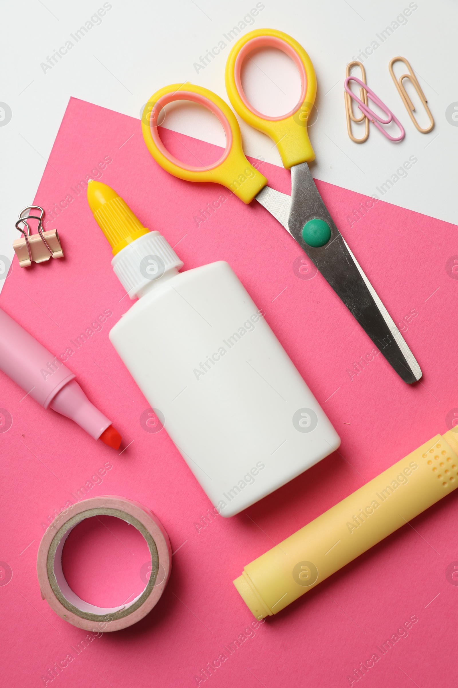 Photo of Glue and other stationery on white background, flat lay