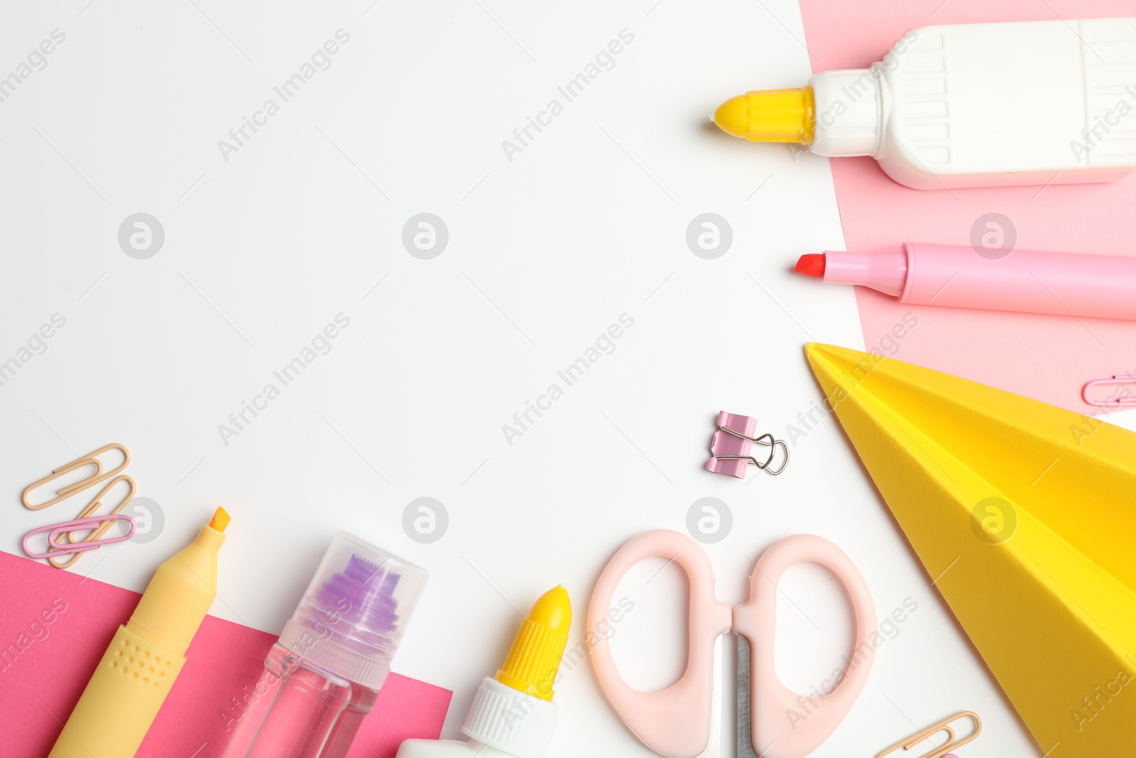 Photo of Glue and other stationery on white background, flat lay. Space for text
