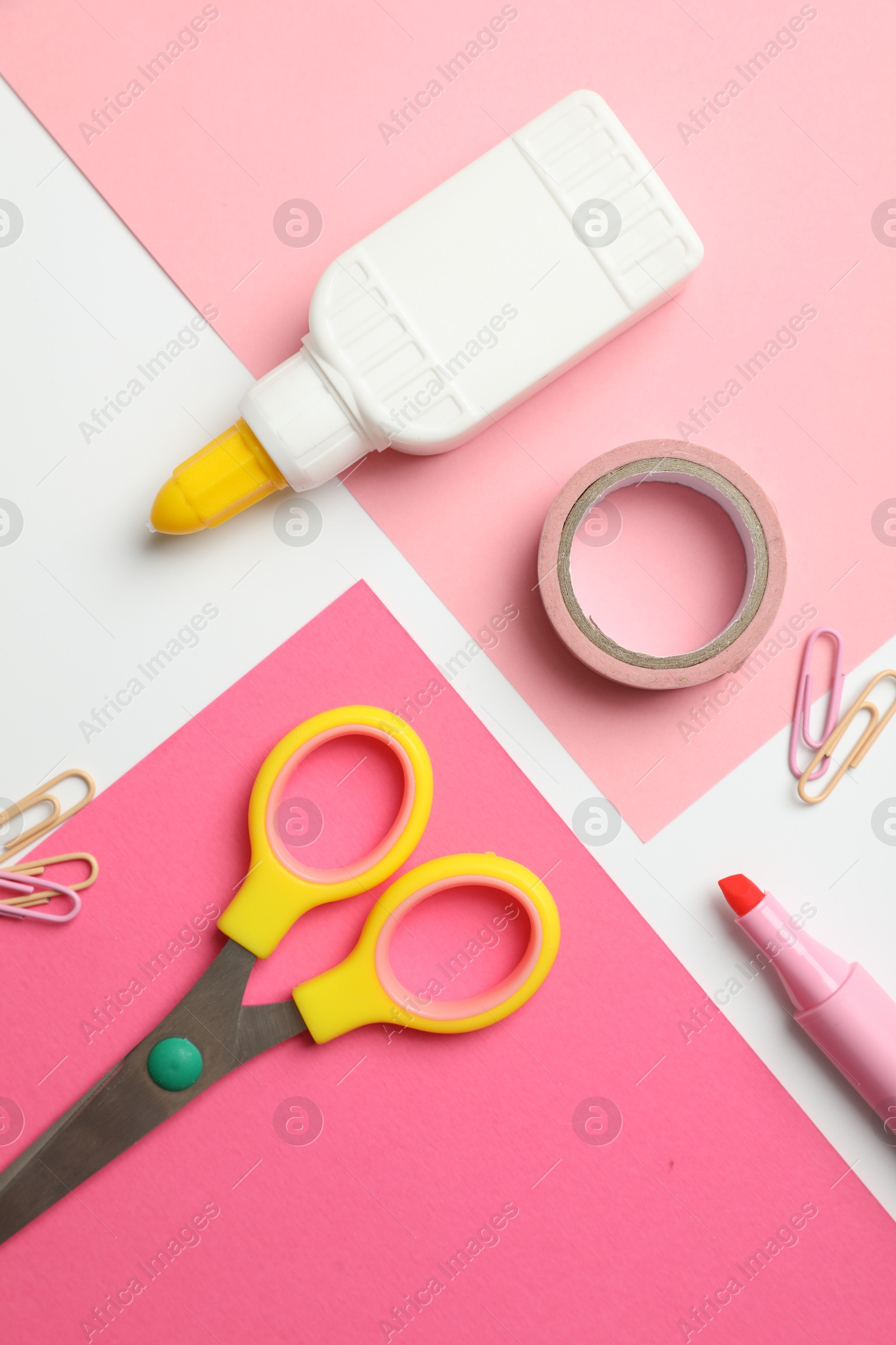 Photo of Glue and other stationery on white background, flat lay