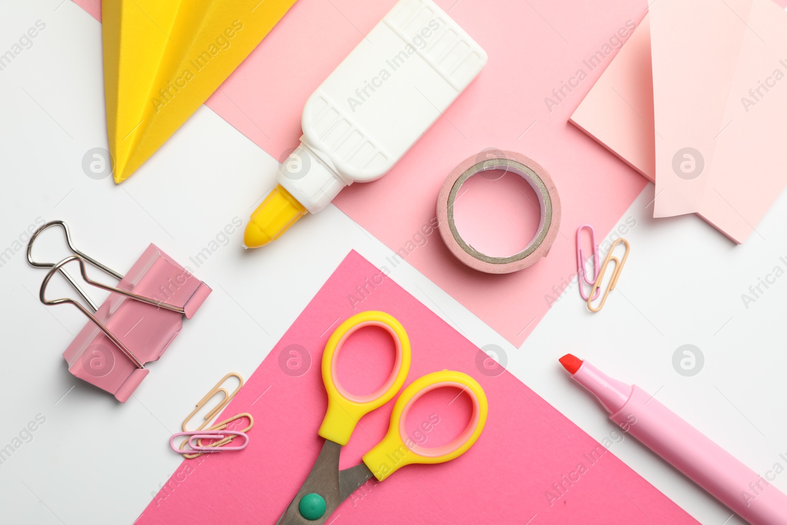Photo of Glue and other stationery on white background, flat lay