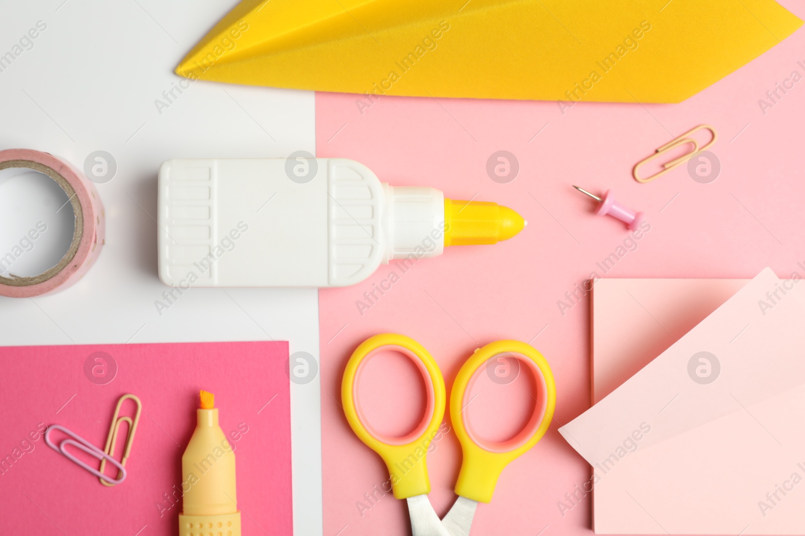 Photo of Glue and other stationery on white background, flat lay