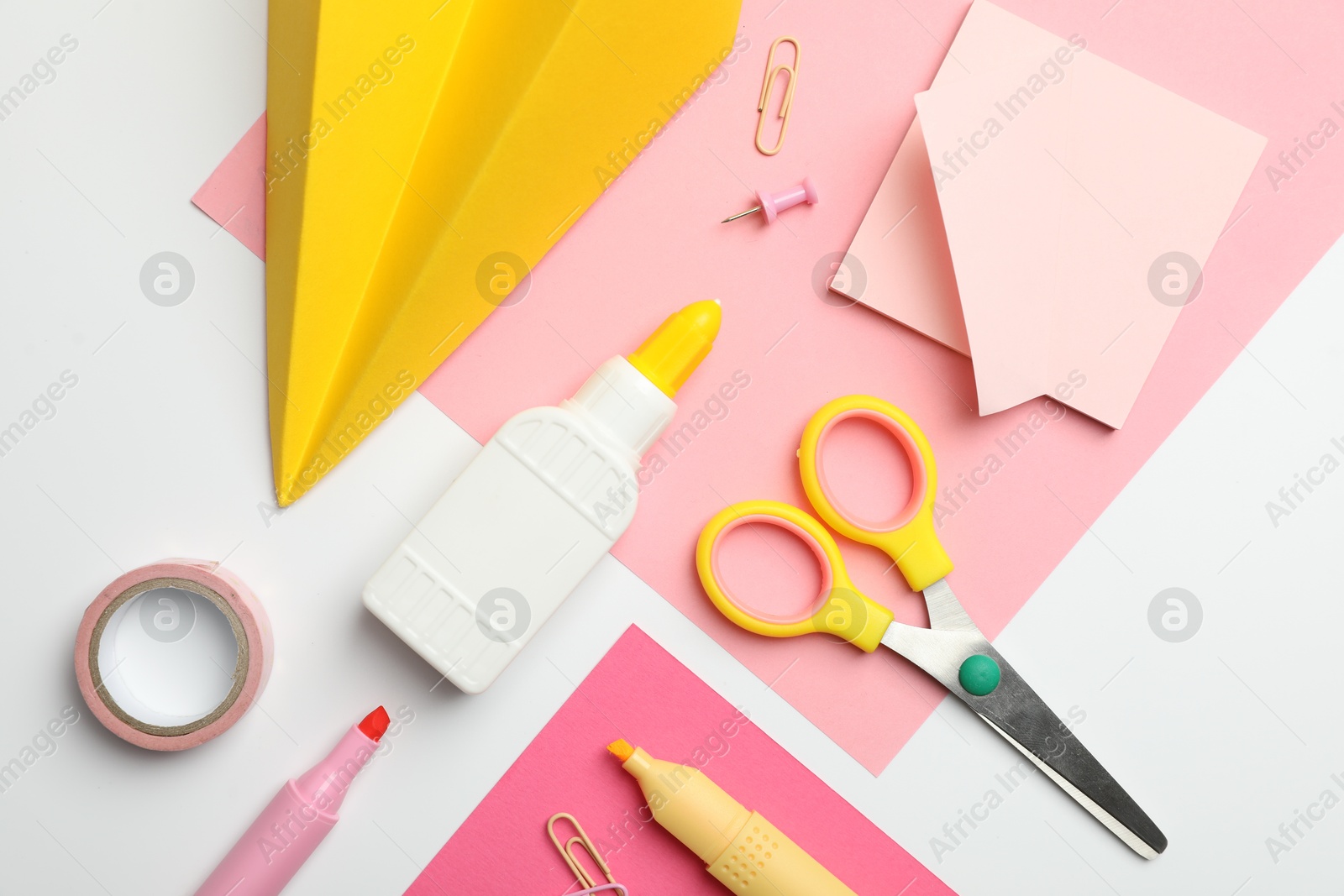 Photo of Glue and other stationery on white background, flat lay