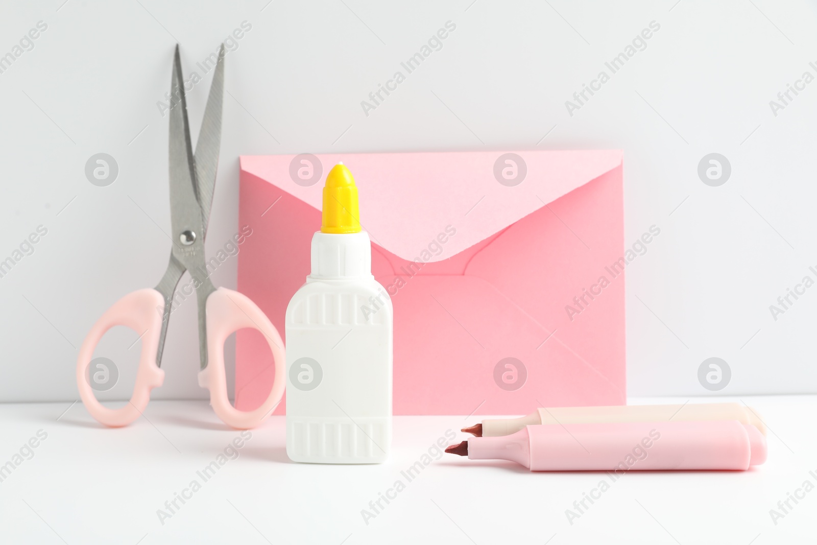 Photo of Glue and other stationery on white table