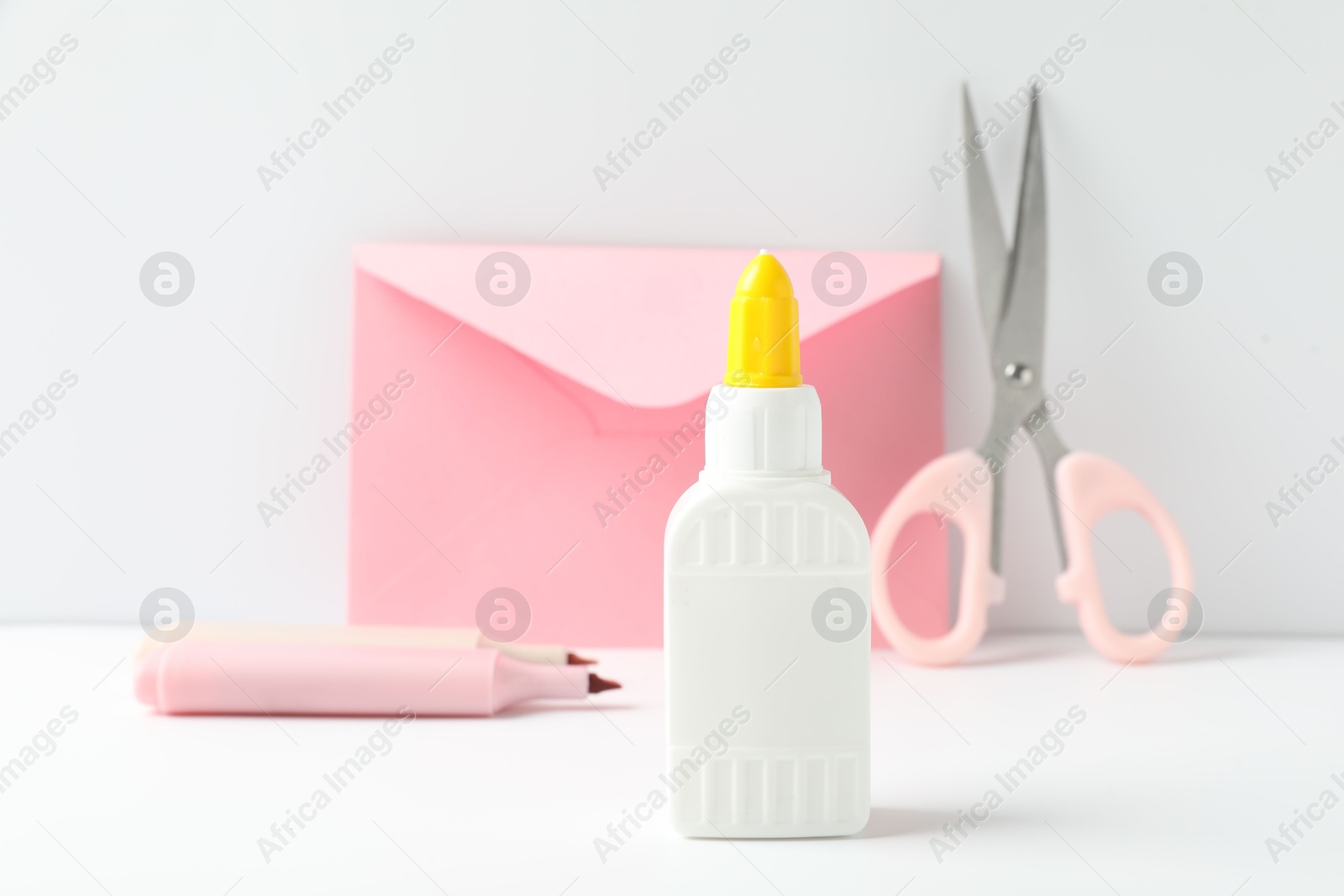 Photo of Glue and other stationery on white table